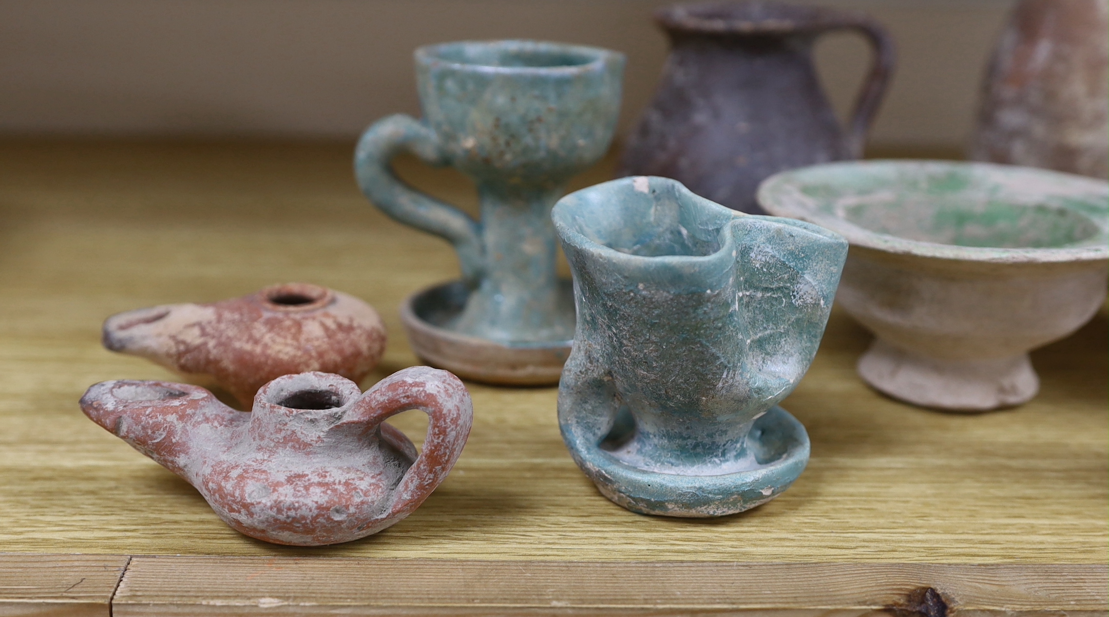 A group of pottery ‘antiquities’, to include Roman, early Christian, Byzantine and Syrian, the largest 17cm high (9), provenance: the owner collected these items in the 1970s, some with original receipts